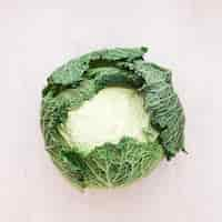 Free photo whole fresh savoy cabbage on wooden surface