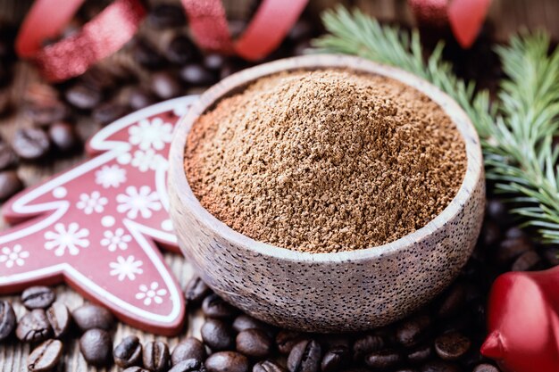 Premium Photo | Whole and ground coffee beans with christmas decorations.