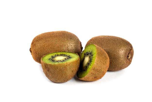 Whole kiwi fruits and half kiwi fruits on white. 