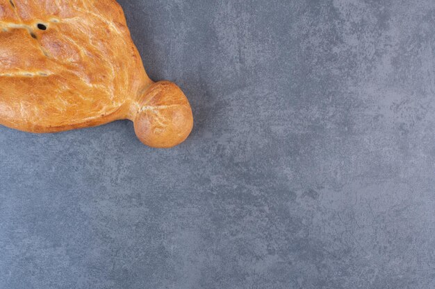 Whole loaf of tandoori bread on marble background