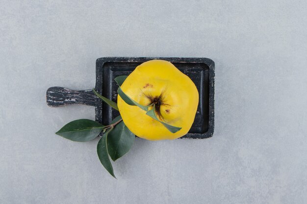 Whole ripe quince on cutting board