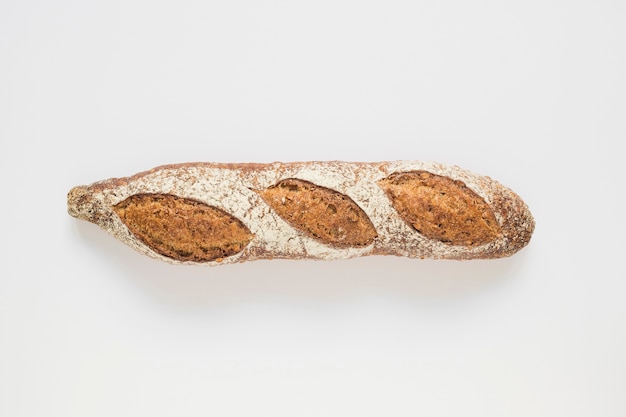 Whole rustic baked baguette on white background