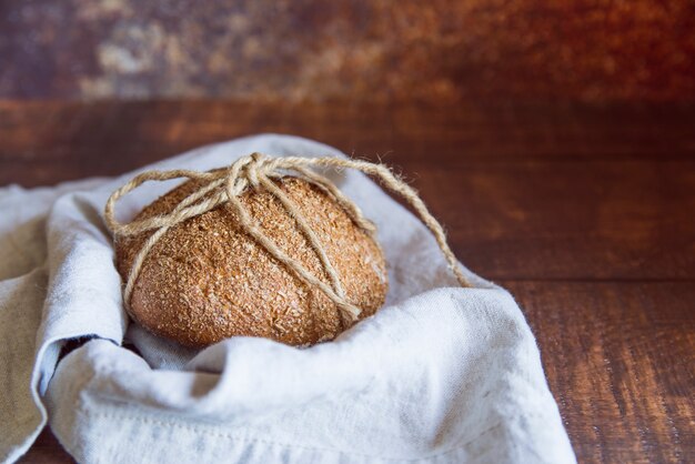 Whole wheat bun on a cloth close up