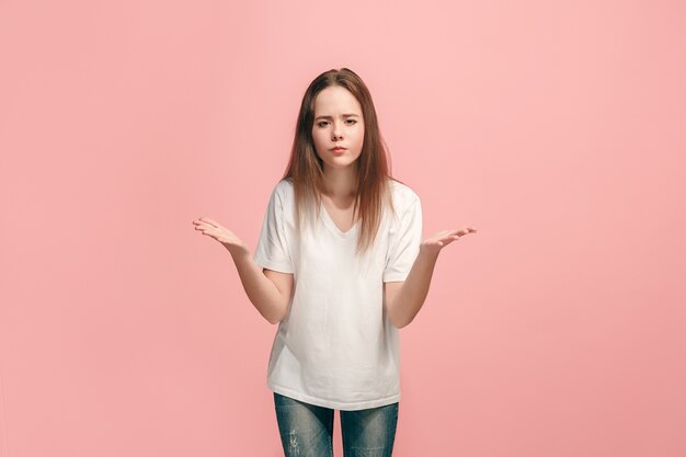 Why is that. Beautiful female half-length portrait on trendy pink. Young emotional surprised, frustrated and bewildered teen girl