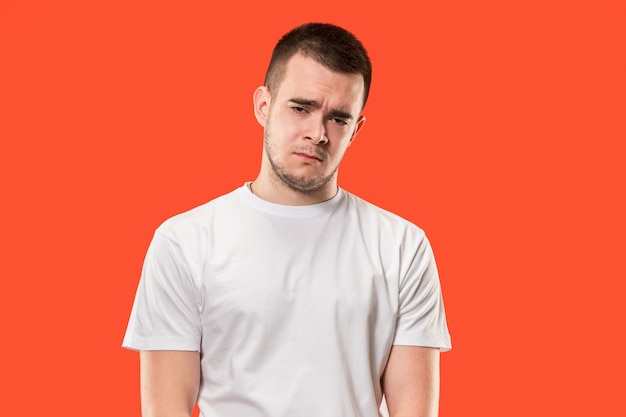 Free photo why is that. beautiful male half-length portrait isolated on trendy orange studio