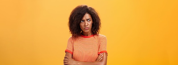 Free photo why life so cruel and unfair gloomy displeased and sad cute african american young woman with curly