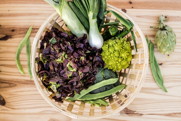 Wicker basket with green vegetables