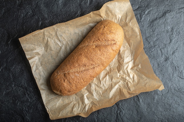 Wide angle photo British Baton loaf bread on paper background.