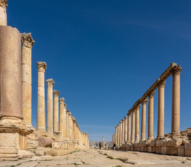 Wide angle shot of an ancient construction with towers in Jordan under a clear blue sky