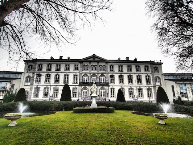 Wide angle shot of a building in front of a park