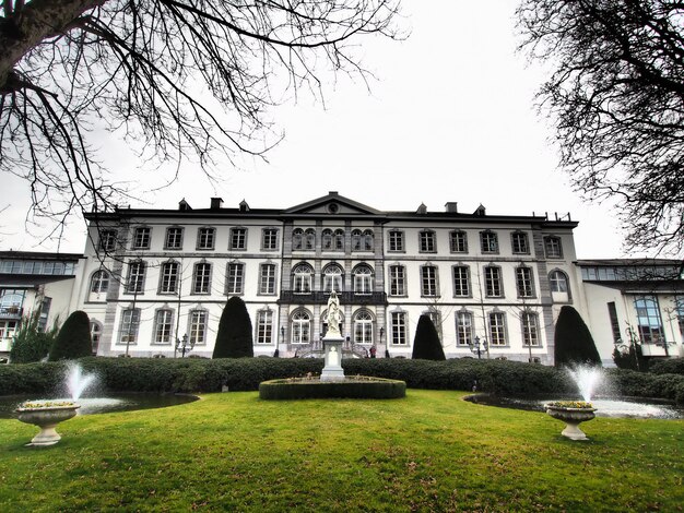 Wide angle shot of a building in front of a park