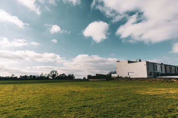 Wide angle shot of a building surrounded by green landscape