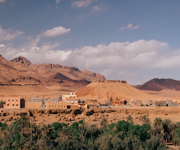 Wide angle shot of the buildings of a city behind the mountains