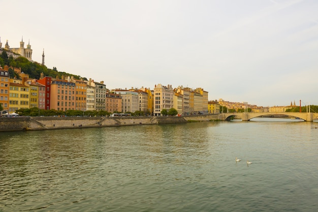 Wide angle shot of the buildings of a city next to the river in France