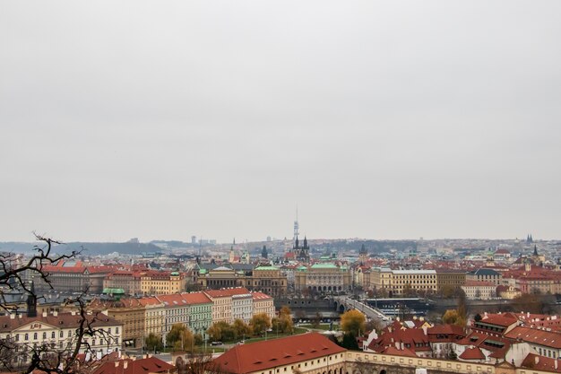 Wide angle shot of the buildings of Prague under a clouded sky