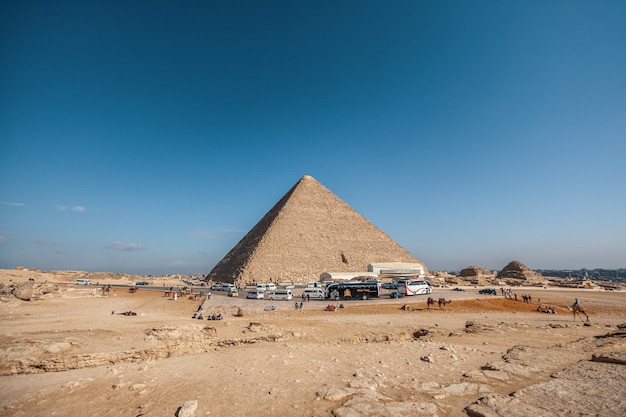 Wide angle shot of an Egyptian pyramid under a clear blue sky