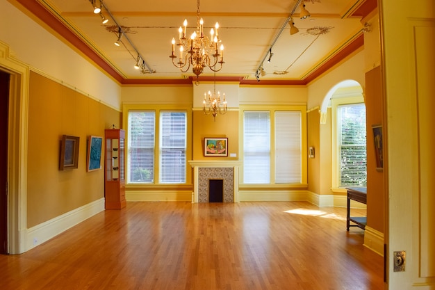 Wide angle shot of the interior of a building, including the pictures, chandelier, and doors