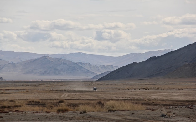 Wide angle shot of a large landscape in front of the mountains