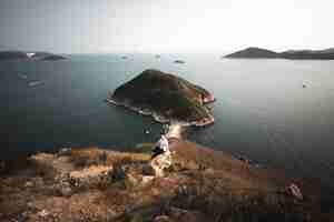 Free photo wide angle shot of mount johnston surrounded by the water in hong kong