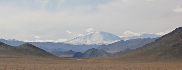 Wide angle shot of the mountains under a clouded sky