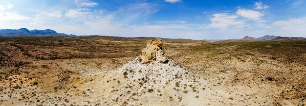 Wide-angle shot of the sandy valley with a rock in the middle