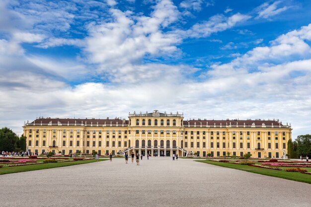 Wide-angle shot of schönbrunn palace in vienna, austria with a cloudy blue sky