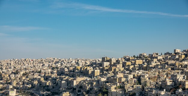 Wide angle shot of several buildings of a city under a clear blue sky