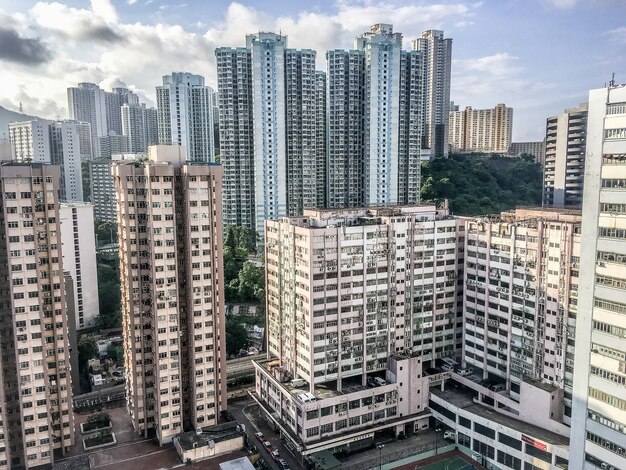 Wide angle shot of several buildings of Hong Kong built next to each other during daytime