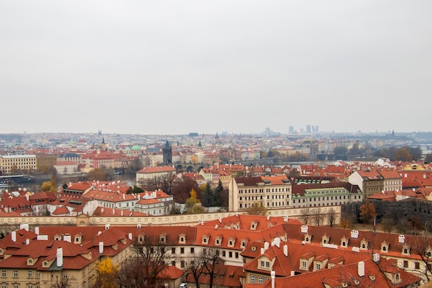 Wide angle view of the buildings of Prague under a clouded sky