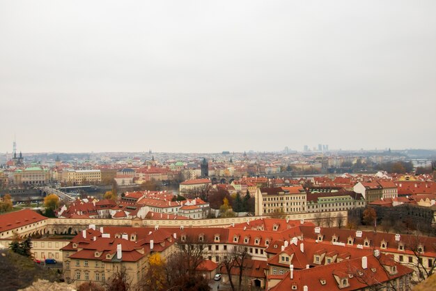 Wide angle view of the buildings of Prague under a clouded sky