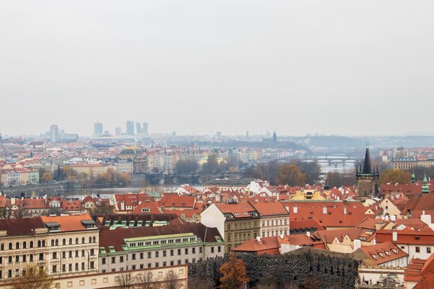 Wide angle view of the buildings of Prague under a clouded sky