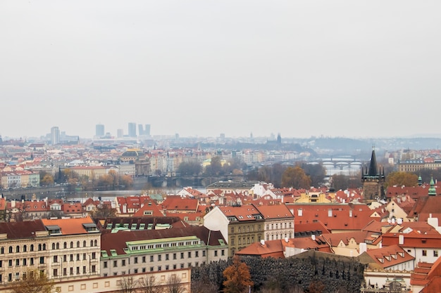 Wide angle view of the buildings of Prague under a clouded sky