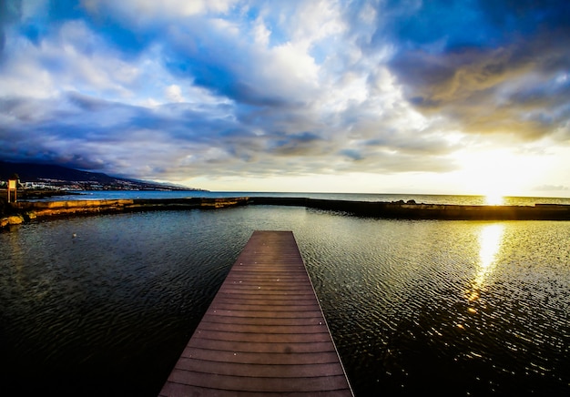 Wide shot of a beach of canary islands in spain with a cloudy sky