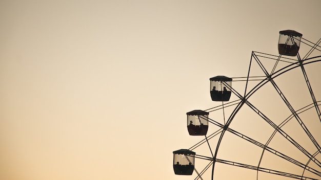 Wide shot of a Ferris wheel on the right with space for text on the left