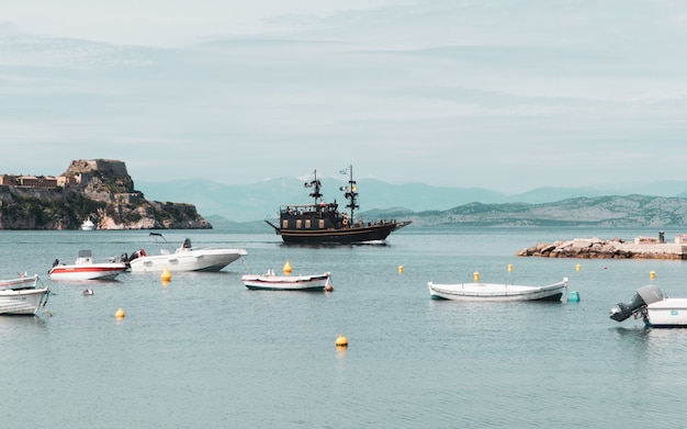 Wide shot of the fishing boats and sailing boats on a lake