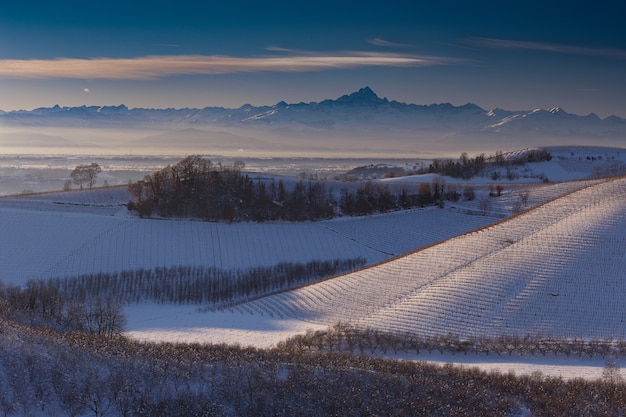 Wide shot of hills covered with snow in langhe piedmont italy