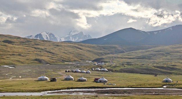 Wide shot of lowlands in the middle-east with tents set up by explorers