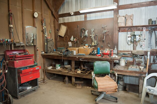 Free photo wide shot of an old barn' s workbench with different types of tools