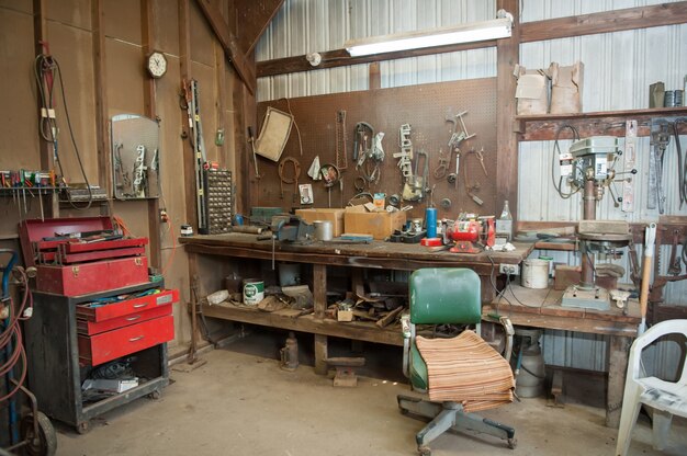 Wide shot of an old barn' s workbench with different types of tools