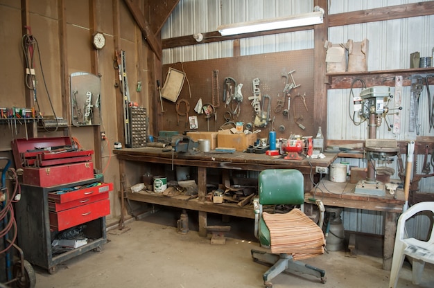 Wide shot of an old barn' s workbench with different types of tools