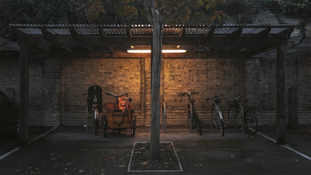 Free photo wide shot of parked bicycles under a shed