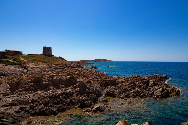 Wide shot of a rocky hill with a castle building