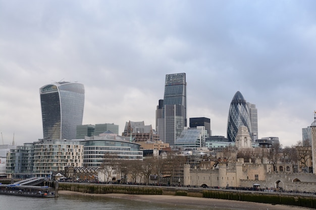 Wide shot of tall glass buildings in London near the lake