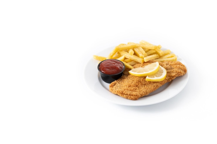 Free Photo wiener schnitzel with fried potatoes isolated on white background