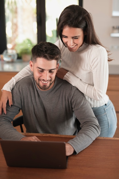 Wife hugging husband medium shot