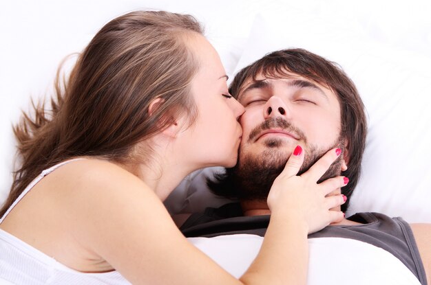 Free photo wife is kissing her husband cheek