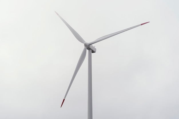 Wind turbine against cloudy sky