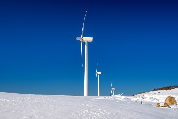 Wind turbine and blue sky in winter landscape