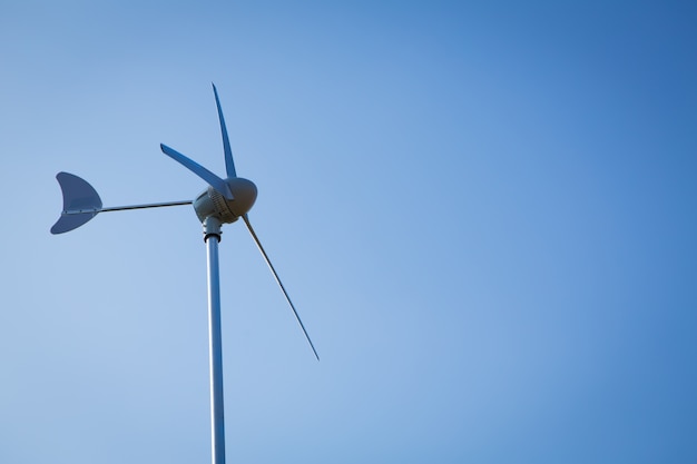 Wind turbine over blue sky