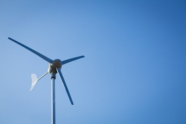 Wind turbine over blue sky